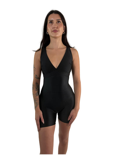 OnTheMarq DropCut™ Scrunchie Black Spandex Shorts Jumpsuit — open crossback with signature scrunchie rear ruching — original bathroom friendly jumpsuit — OnTheMarq proprietary DropCut™ Technology — black spandex shorts jumpsuit — invented by Nita Marquez — Freedom Fashion