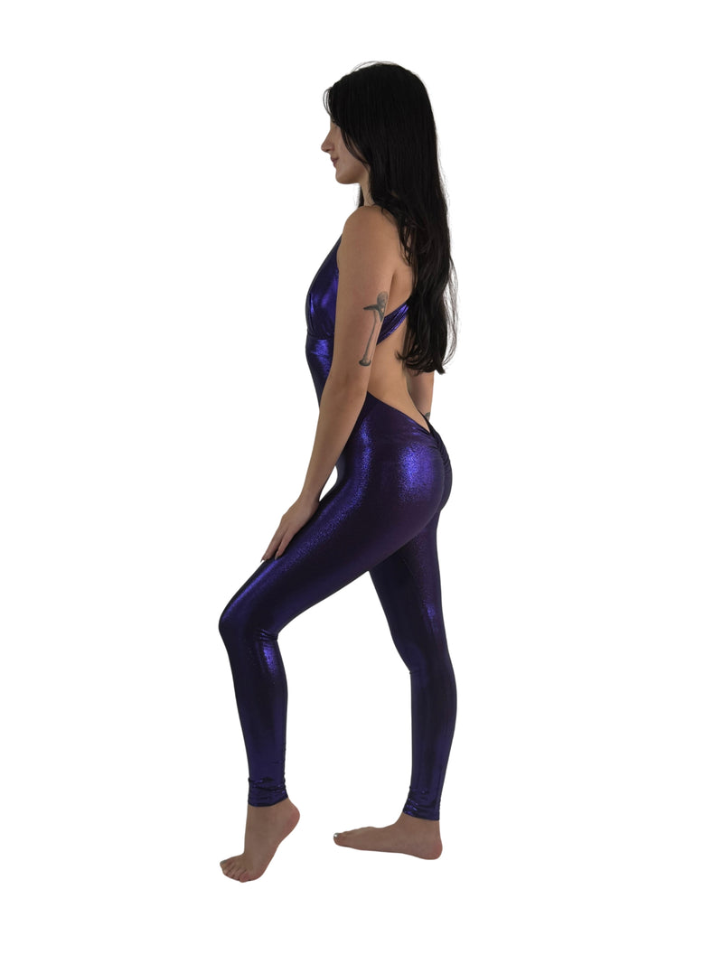 Front View of Model in OnTheMarq DropCut™ Scrunchie Purple Sparkle Jumpsuit — open crossback with signature scrunchie rear ruching — original bathroom friendly jumpsuit — OnTheMarq proprietary DropCut™ Technology — deep royal purple metallic sparkle crossback jumpsuit — invented by Nita Marquez — Freedom Fashion